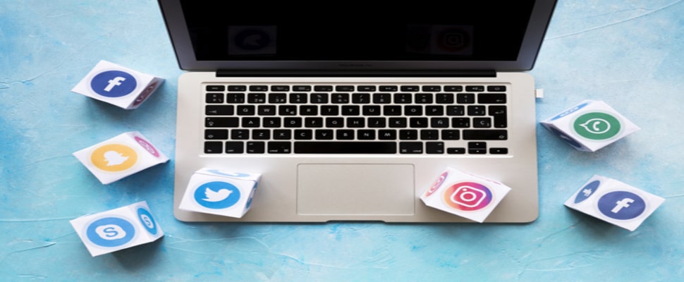 social media icon blocks laptop blue background 23